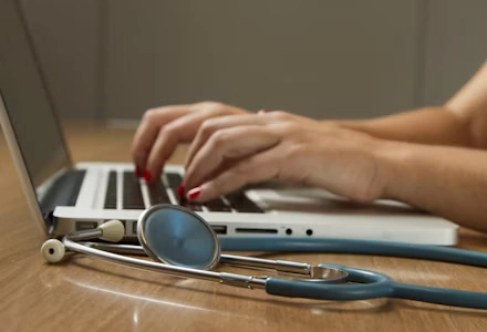 Doctor checking a patient's blood pressure during a preventive health screening