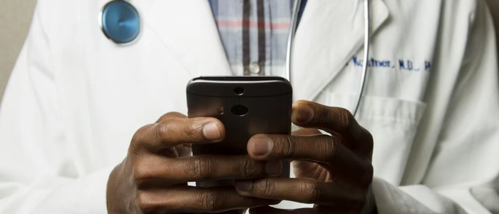 Doctor delivering a telemedicine video consultation from a clinic