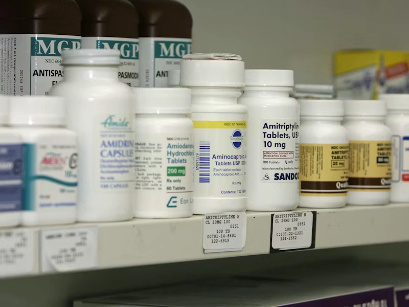 Pharmacy shelf stocked with medicine bottles
