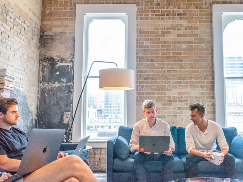 Retail startup team collaborating on laptops in a co-working space