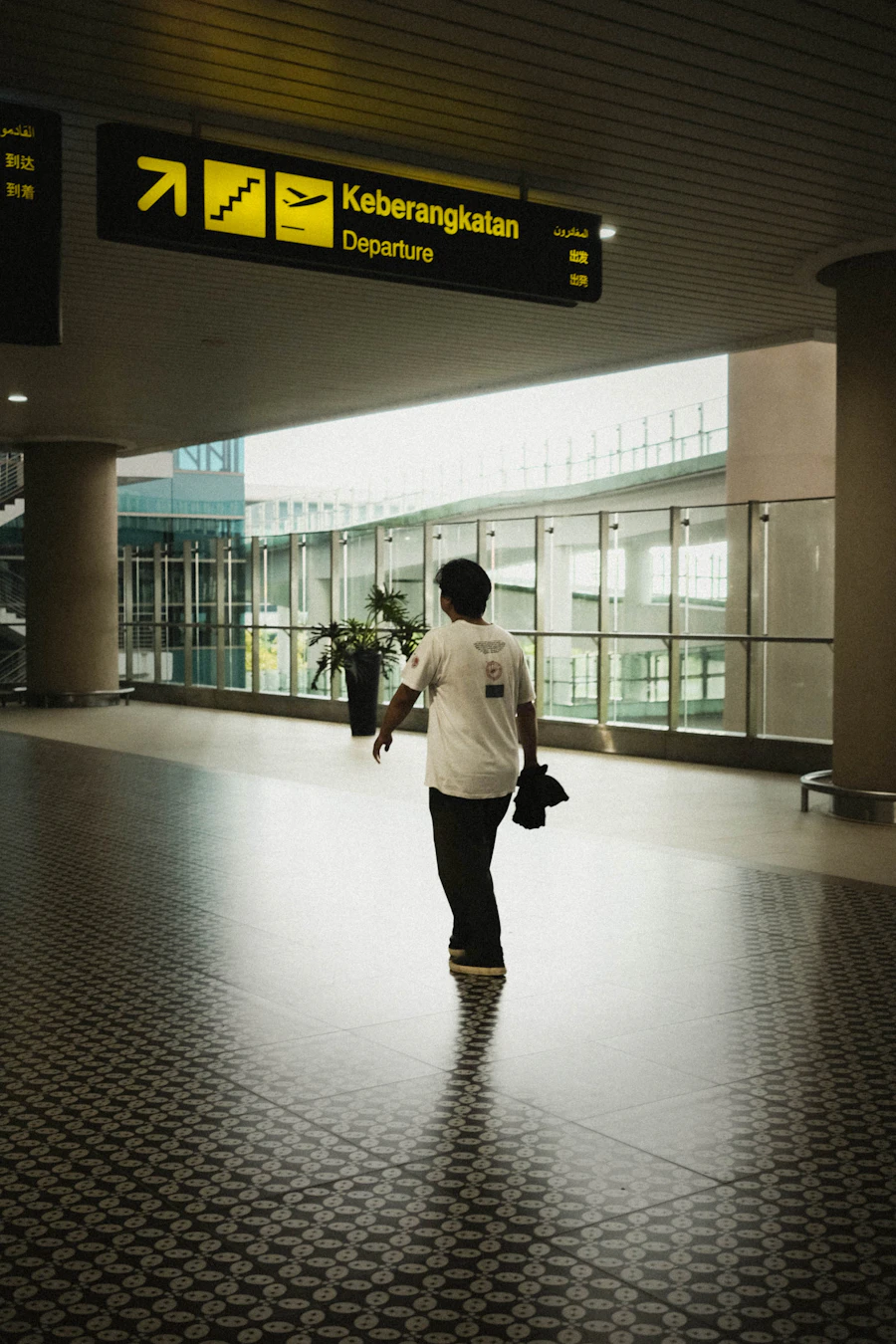 Traveler walking through an airport terminal, representing corporate travel management technology